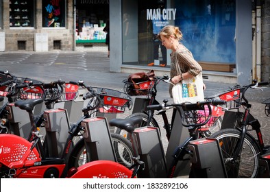 LILLE, FRANCE - July 18, 2013. French Woman Using A Free Rental Bike In Lille, France