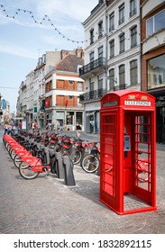 LILLE, FRANCE - July 18, 2013. Free Bike Rental Station And Red British Telephone Box In A Street In Lille, France