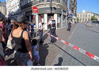 Lille, France - May 26, 2017: Crowd Of People Watch Behind Barrier Tape As French Police Officers Investigate Bomb Threat In A Street In The Center Of Lille, France On May 26, 2017