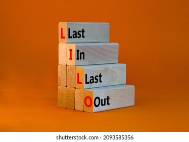 LILO last in and out symbol. Concept words LILO last in last out on wooden blocks. Beautiful orange table, orange background. Business and LILO last in and out concept. Copy space.