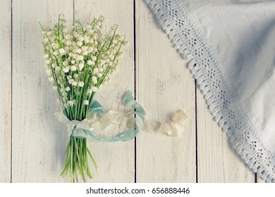 Lily Of The Valley Bouquet On Wooden Background. Spring Season. Romantic Floral Composition. Lily Of The Valley Day In France. Top View