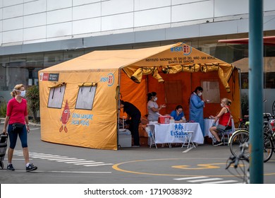 Lima, Peru - April 30 2020: Tent For Blood Donation Amid Coronavirus Pandemic. Nurse And People Wearing Masks In COVID-19 Times.