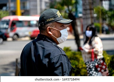 Lima, Peru - April 4 2020: Policeman wearing a mask amid coronavirus outbreak in South America. Officer patrolling the streets at COVID-19 times.