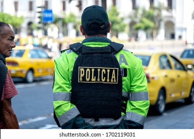 Lima, Peru - February 17 2019: Police Men Back With Bulletproof Vest And Neon Uniform. City Traffic In The Background.