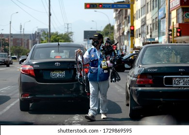 Lima, Peru - May 12 2020: Ambulant Seller At A Traffic Light Wearing A Mask Amid Coronavirus Pandemic In South America.