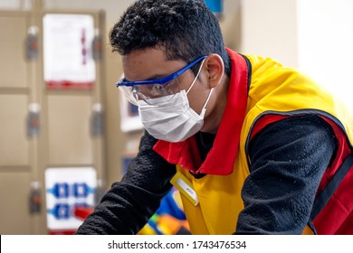 Lima, Peru - May 26 2020: Plaza Vea Supermarket Worker Wearing A Mask And Glasses Amid Coronavirus Outbreak In South America.