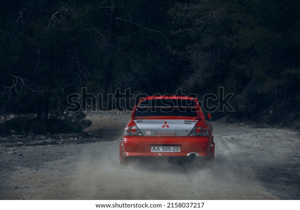 Limassol, CY - OCT\
13, 2018: Mitsubishi Lancer Evolution VI Tommi Makinen Edition go\
fast with clouds of\
dust