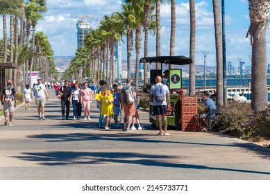 Limassol, Cyprus - October 21, 2021: People Walking By Seafront On A Sunny Day