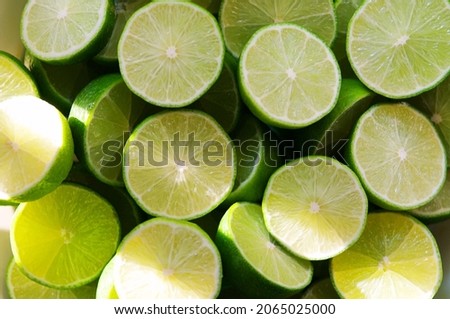 Lime Background with sun light from outside. Close up shot of limes. Selective Focus of sliced lime. Lime is a kind of fruit. The result is very sour for cook the Thai food style