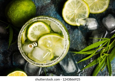 Lime cocktails with marijuana on stone table top view