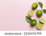 Lime fruits with green leaf and cut in half slice isolated on white background. Top view. Flat lay with copy space.