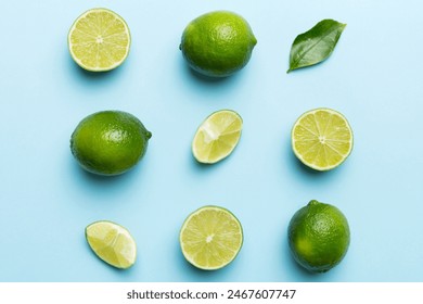 Lime fruits with green leaf and cut in half slice isolated on white background. Top view. Flat lay with copy space. - Powered by Shutterstock