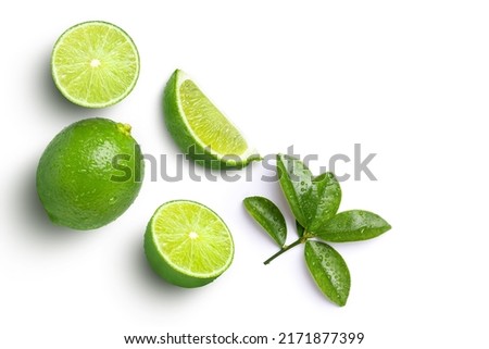 Lime fruits with green leaf and cut in half slice isolated on white background, top view, flat lay.