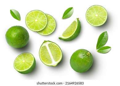 Lime fruits with slices and green leaves isolated on white background. Top view. Flat lay. - Shutterstock ID 2164926583