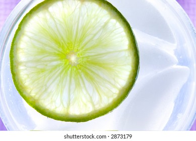 Lime Garnish, Shot Top Down In A Glass Of Water.