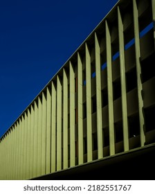 Lime Green Building Facade Under Blue Sky With Room For Text.