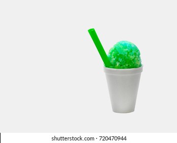 Lime Green Hawaiian Shave Ice, Shaved Ice, Snow Cone Or Snow Ball In A White Cup  With A Green Straw.