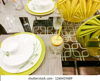 Lime Green Plates, Mason Jar, Lamp And Napkins Sitting On A Glass Table. Very Modern Cutlery For A Contemprory Home. Makes Great Holiday Table Ware