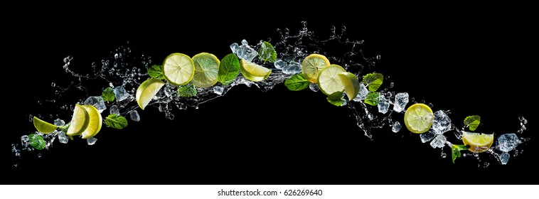 Lime and lemon pieces with mint and ice in water splash