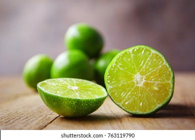 Lime And Limes Slice On Wooden Table.