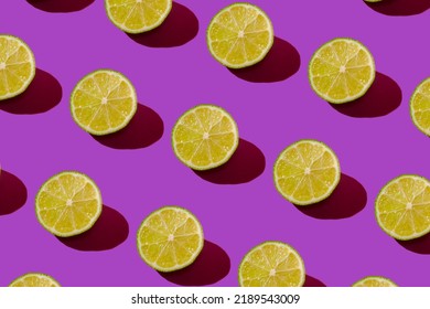 Lime pattern on a purple background. Pop art design, creative citruses. Yellow lemon, minimal flat style. High quality photo