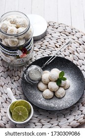 Lime Snow Ball Cookies On Black Plate