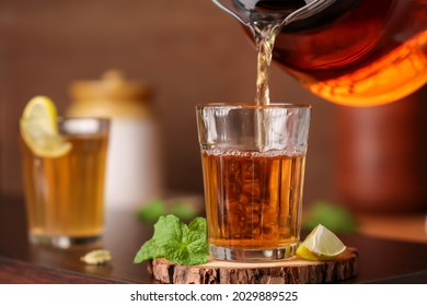 Lime tea , pouring black tea Chai traditional beverage with lemon spices Kerala India. Two glass of organic ayurvedic or herbal drink India, green tea good in winter for immunity boosting.