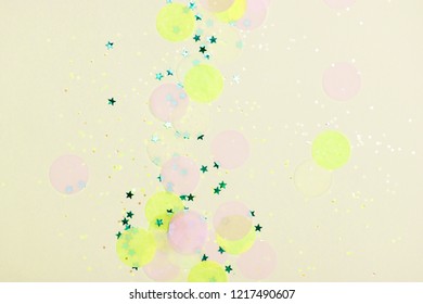 Limelight yellow holiday background with confetti. Bright and festive. Color of autumn 2019.