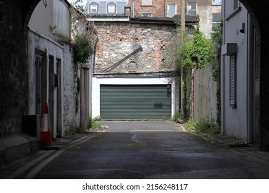 Limerick Ireland 05 07 2022: Garage At The End Of A Dark Ally In An Old City Centre