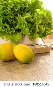 Limes And Lettuce On Wooden Table