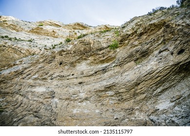 Limestone cliff above the spring of the Sorgue river in Fontaine-de-Vaucluse village in Provence, France