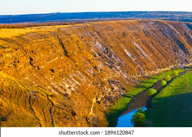 Limestone cliffs at the riverside . Panoramic landscape with cliffs and river 