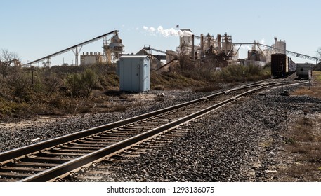 Limestone Extraction Open Mining Pit , Pollution And Climate Change. Factory In Texas Producing Fossil Fuel Smoke Stack And Train Tracks Leading To Industrial Revolution Style Like