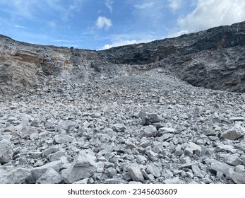 Limestone mining, bench of limestone after blasting.