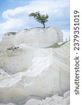 limestone quarry. Large limestone quarry,crushed stone in the foreground, mining site, calcium carbonate quarry. Calcareous, Chalk hills. Lonely Tree on top of limestone quarry in Fetesti, Moldova.