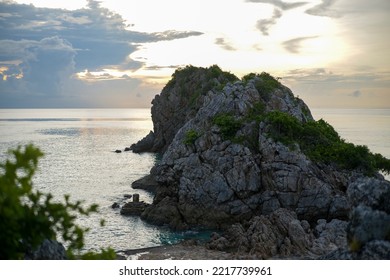 Limestone Rock Formations At Sunset Surrounded By Calm Ocean Background Image.