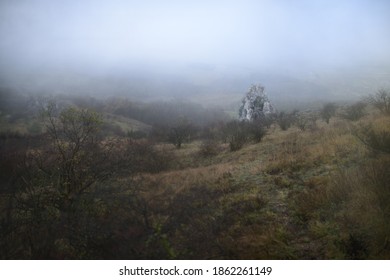 Limestone rock on the hillside of Table Mountain in the protected landscape area of ​​Pálava surrounded by autumn fog.