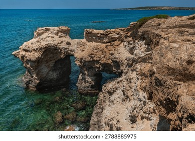 Limestone Sea Arch and Dramatic Clouds Over Mediterranean Coast