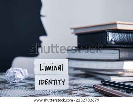 Liminal Identity inscription on painted wooden chips on workplace. Person associated with liminality concept.