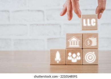 Limited Liability Company (LLC) Business Concept, Person Hand Holding Wooden Block With Limited Liability Company Icon On Vr Screen.