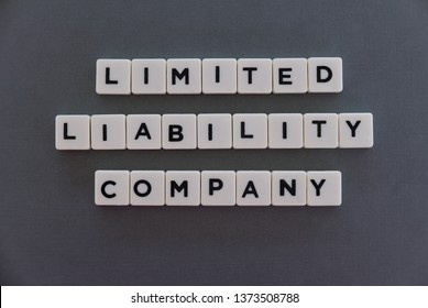 Limited Liability Company (LLC) Word Made Of Square Letter Word On Grey Background.