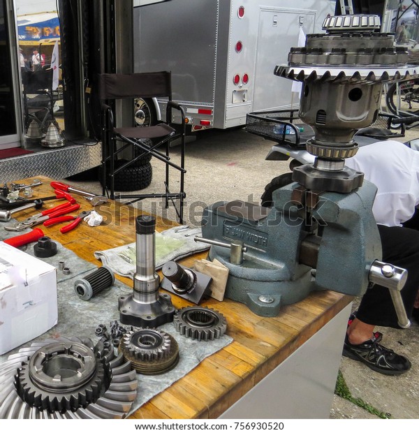 A limited slip differential being\
rebuilt on mechanic\'s row at an international\
raceway.