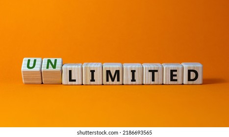 Limited or unlimited symbol. Turned wooden cubes and changed words 'limited' to 'unlimited'. Beautiful orange background, copy space. Business, limited or unlimited concept.