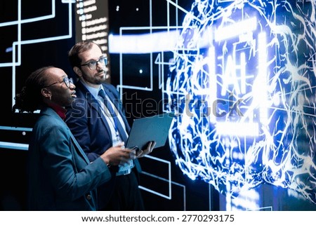 Limiting AI autonomy, laptop and engineering team brainstorming how to do risk mitigation. Enforcing artificial intelligence agent guardrails, notebook and RD lab coworkers cooperating