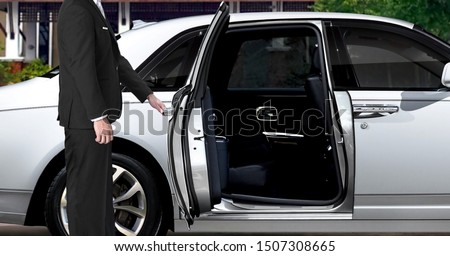 Limo driver opening white car door 