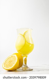 Limoncello Cocktail With Lemon In A Beautiful Glass On A Light Background And A Marble Table