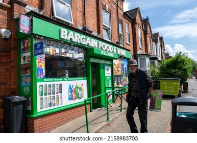 Lincoln, Lincolnshire, England - May 17, 2022. Bargain Food And Wine Shop With Man Passing By On Monks Road.