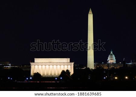 Lincoln Memorial, Washington Monument, and National Capitol at night. View from Arlington. Washington DC, USA.	