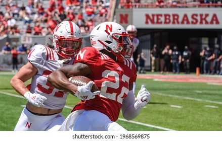 Lincoln, Nebraska, USA - May 1, 2021: Nebraska Football Runningback Gabe Irvin Jr. Runs Away Tacklers In The Annual Red-White Spring Game At Memorial Stadium In Lincoln.