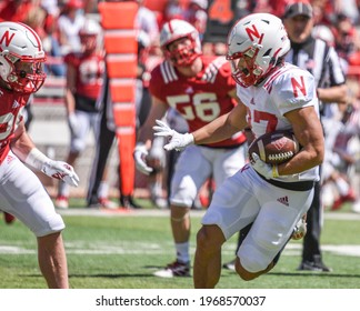 Lincoln, Nebraska, USA - May 1, 2021: Nebraska Football Runningback Isaiah Harris Runs Away Tacklers In The Annual Red-White Spring Game At Memorial Stadium In Lincoln.